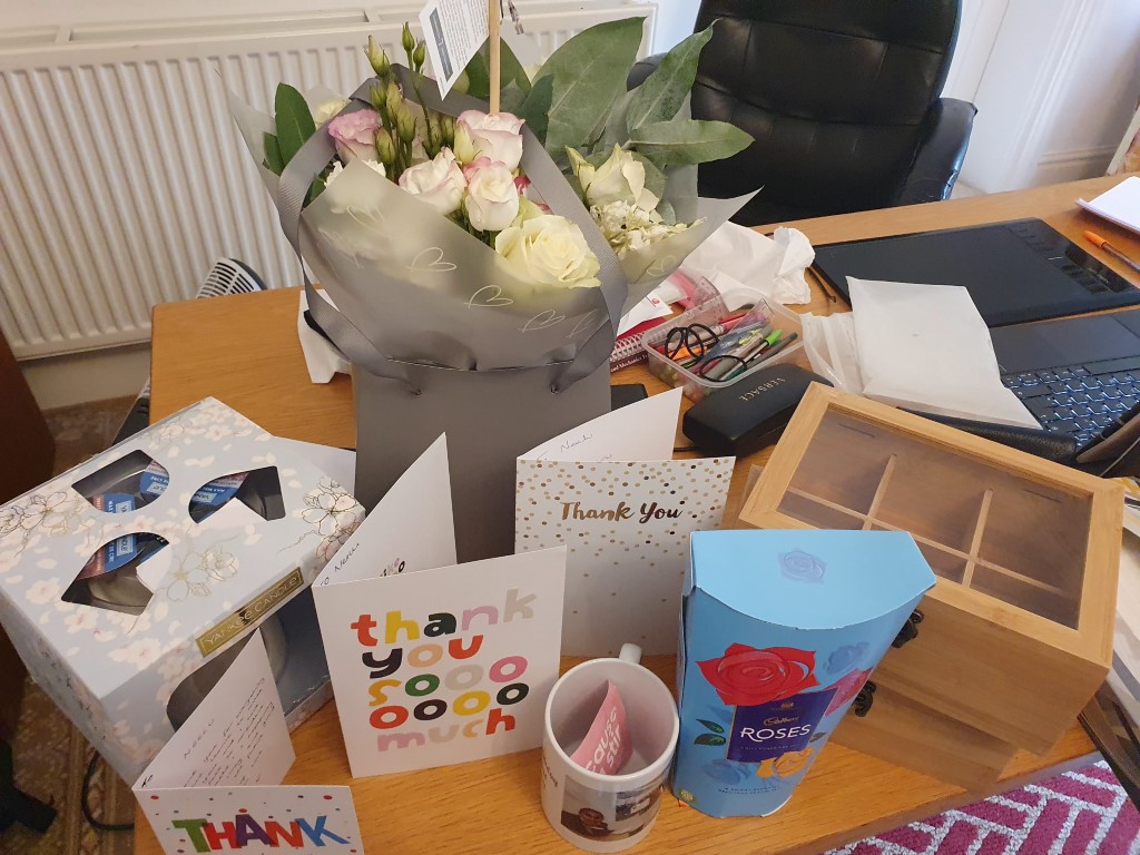 Thank-you cards and gifts from pupils covering Neelu's desk